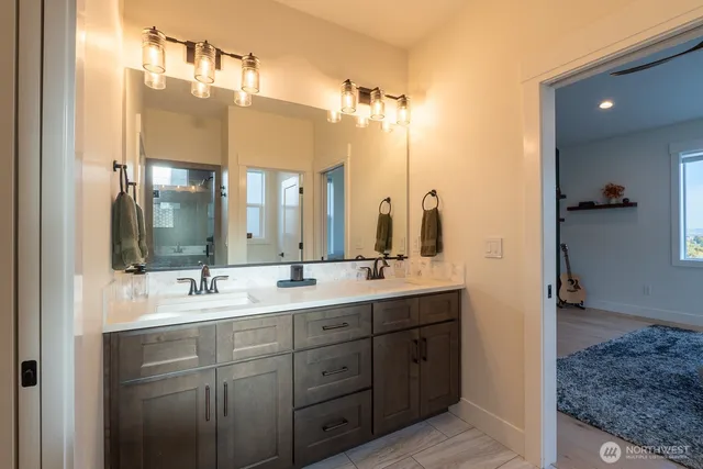 a bathroom with a double vanity sink mirror and double