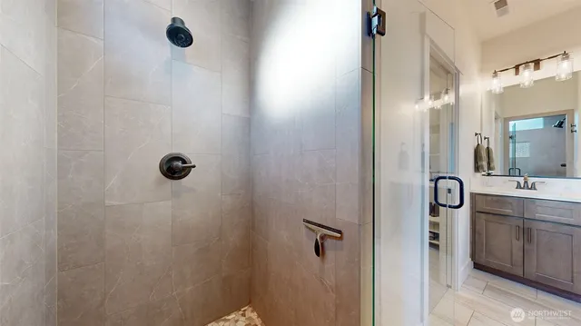 a bathroom with a shower and a sink