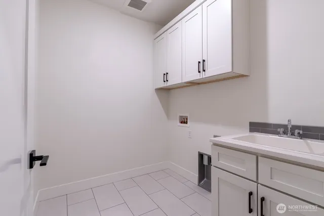 a bathroom with a sink and cabinets