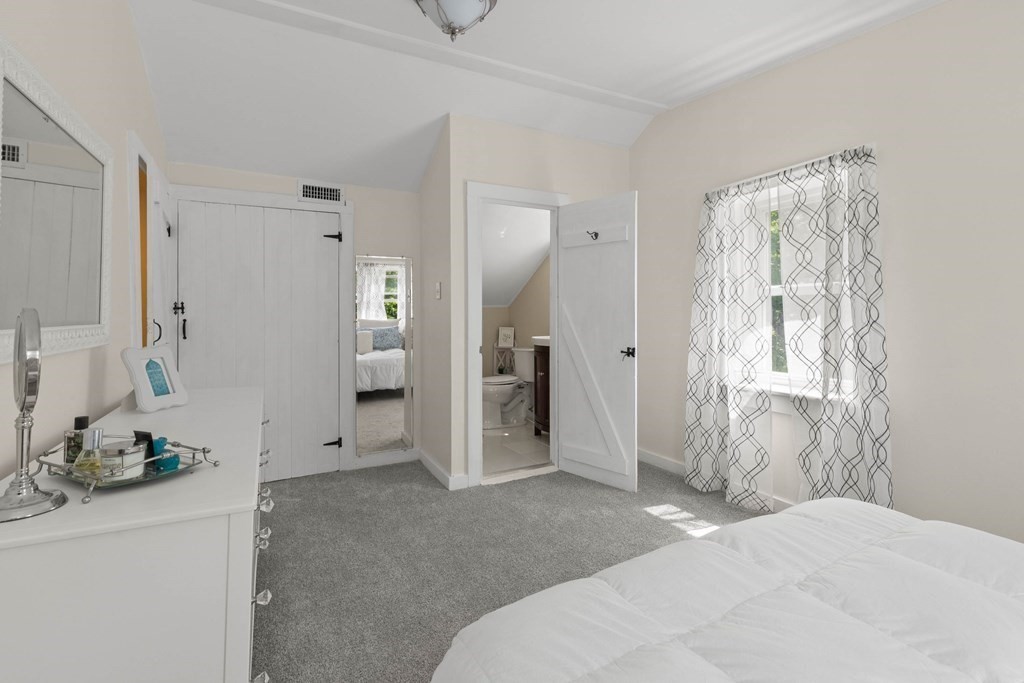38 Elm Street Georgetown, MA 01833 - Photo 22 of 41 a bedroom with a bed and a large mirror