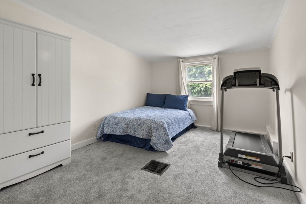 38 Elm Street Georgetown, MA 01833 - Photo 24 of 41 a bedroom with a bed and a window