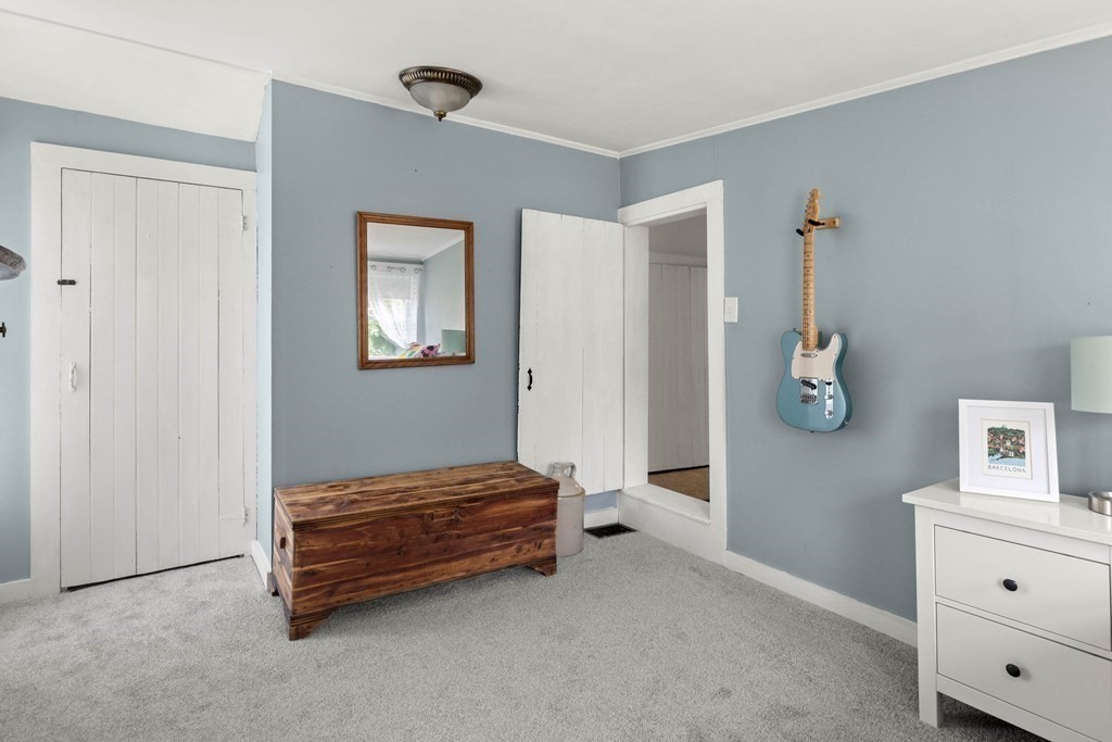 38 Elm Street Georgetown, MA 01833 - Photo 26 of 41 a bedroom with a bed and cabinet