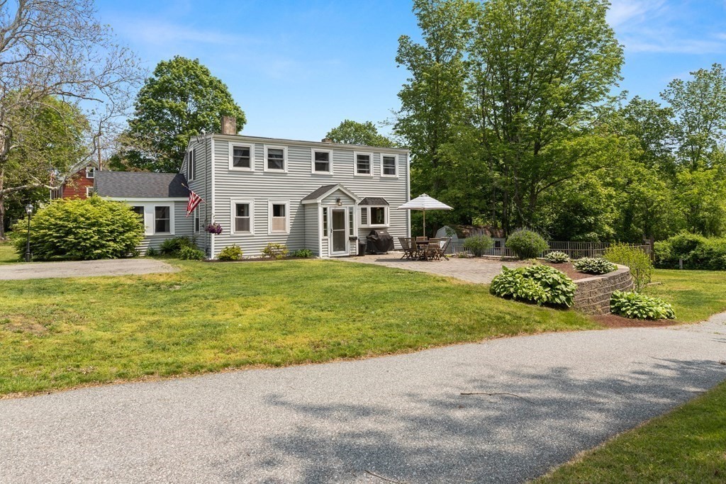 38 Elm Street Georgetown, MA 01833 - Photo 28 of 41 a front view of a house with a yard