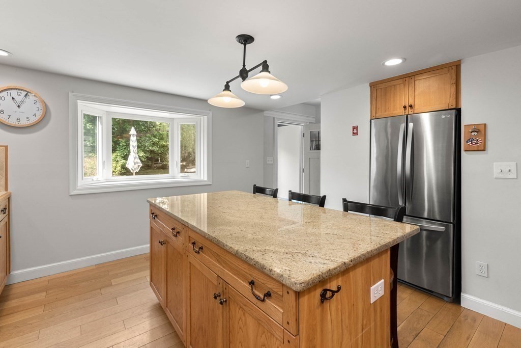 38 Elm Street Georgetown, MA 01833 - Photo 8 of 41 a kitchen with granite countertop a table and chairs