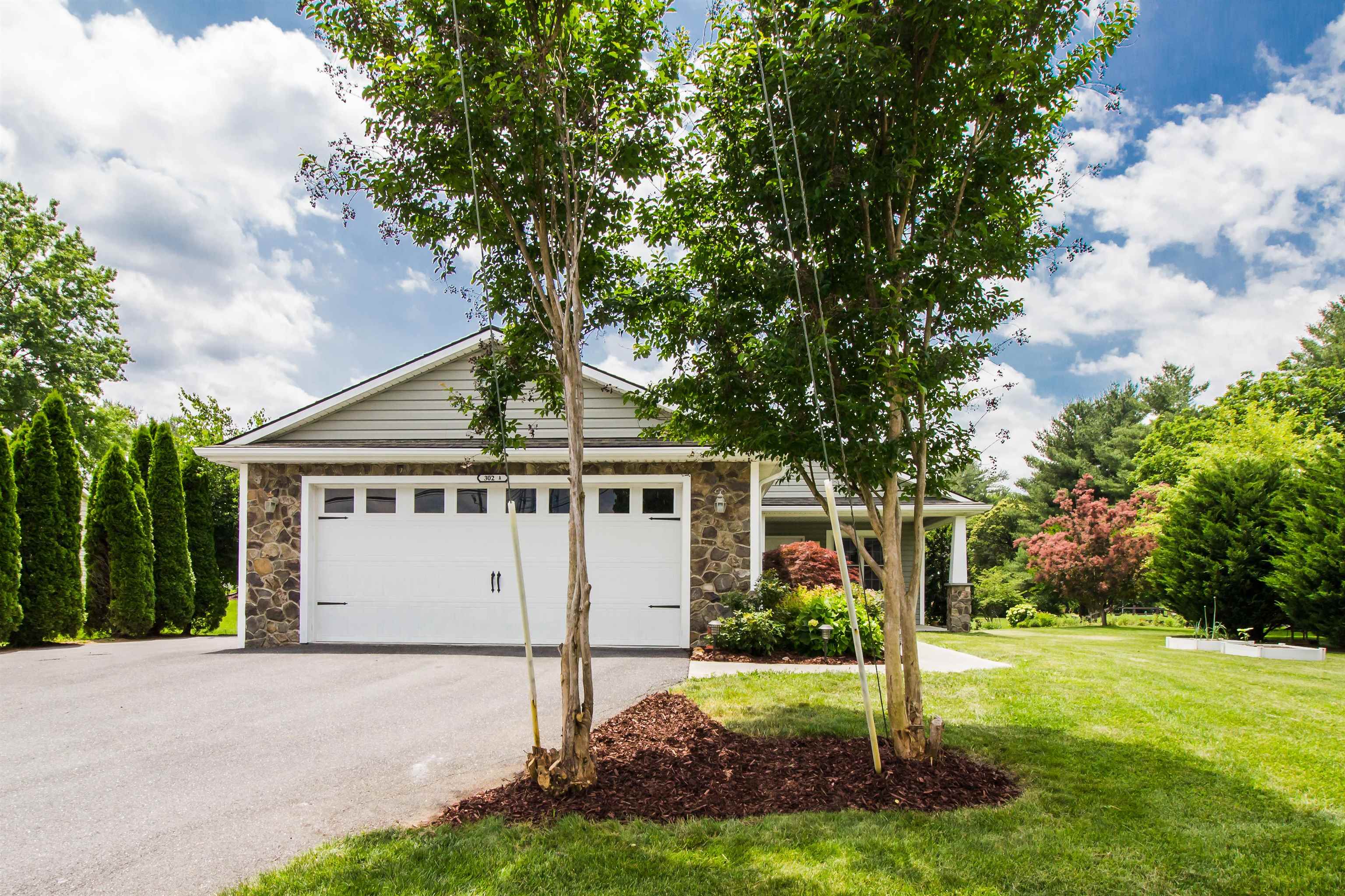 302 A North River Road Bridgewater, VA 22812 - Photo 1 of 24 a view of a yard in front of a house with plants and large tree