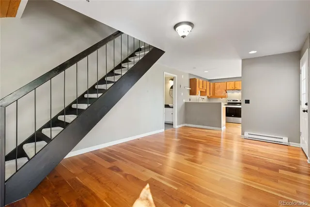 a view of a kitchen with wooden floor and electronic appliances