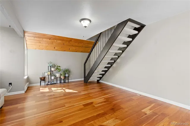 a view of an empty room with stairs and ventilation