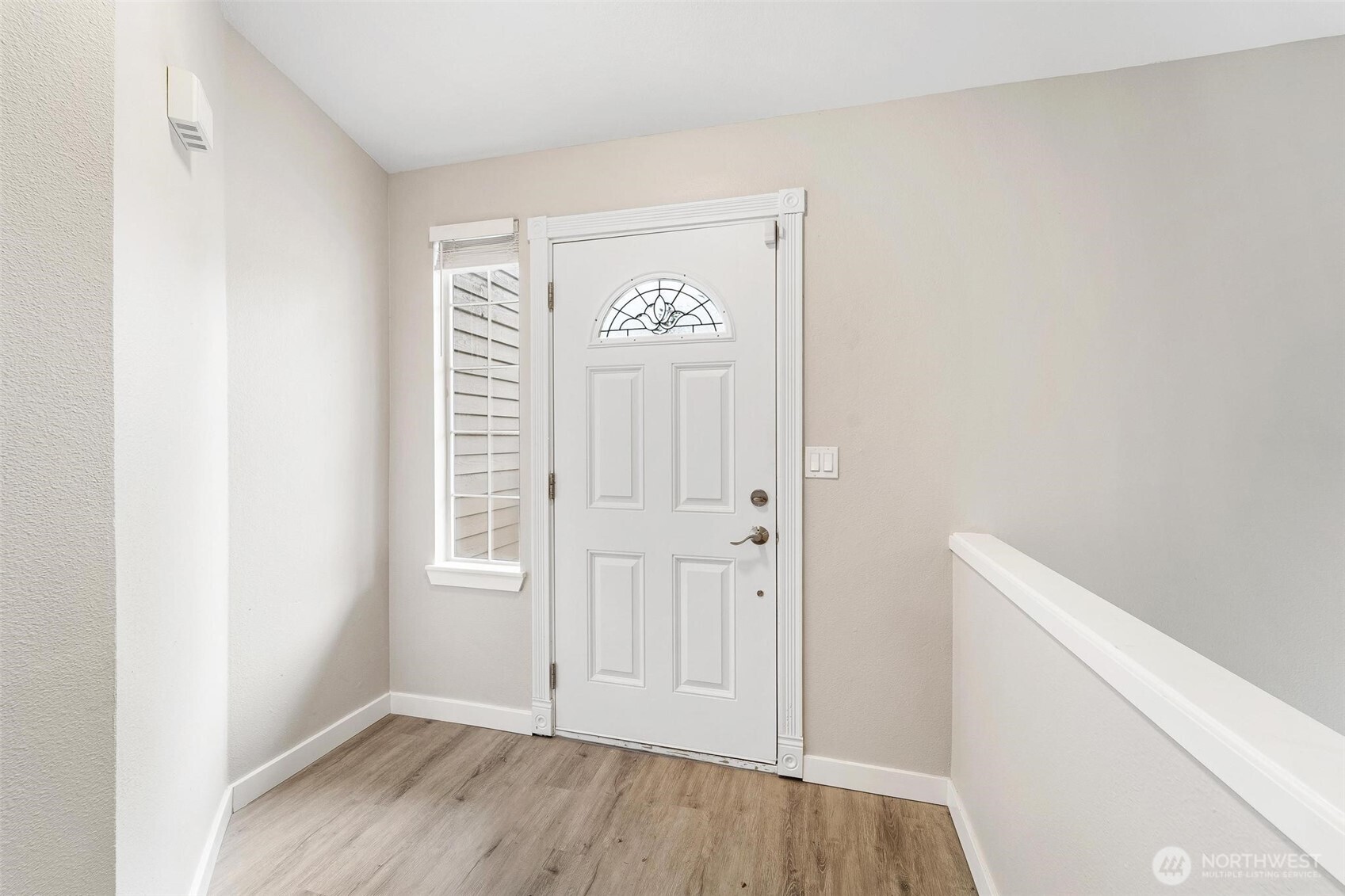 604 213th Street Southwest Bothell, WA 98021 - Photo 8 of 40 a view of an empty room with wooden floor and a window
