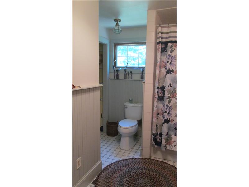 587 Ten Rod Road North Kingstown, RI 02852 - Photo 16 of 20 Bathroom. The bath has tile floors, wainscoting on the walls and a storage closet.