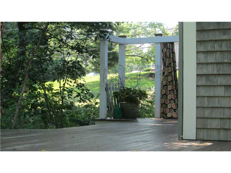 587 Ten Rod Road North Kingstown, RI 02852 - Photo 18 of 20 Patio/Deck. A Meranti mahogany deck wraps around the side & rear of the house. It is accessed through the French doors in the Dining Room.