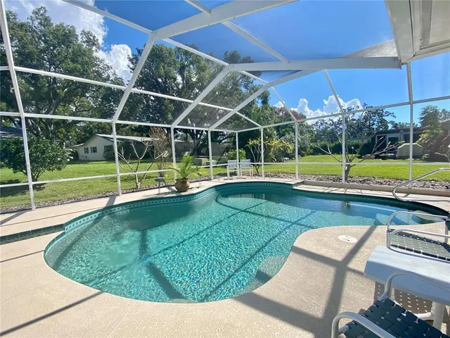 an aerial view of a swimming pool yard and outdoor seating