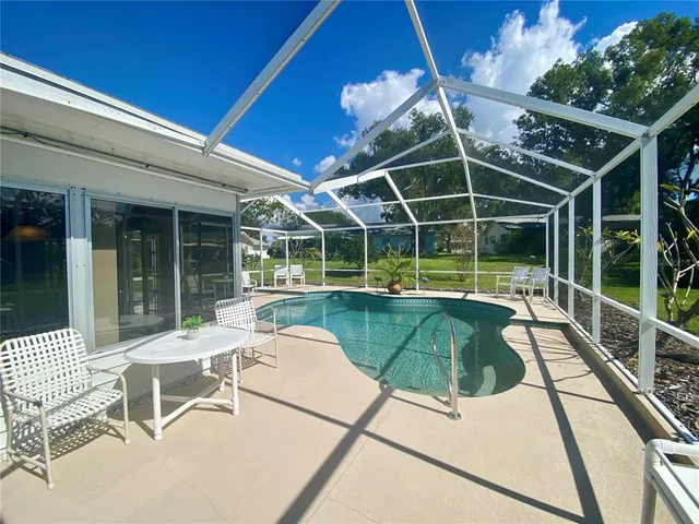 an aerial view of a residential houses with outdoor space and street view