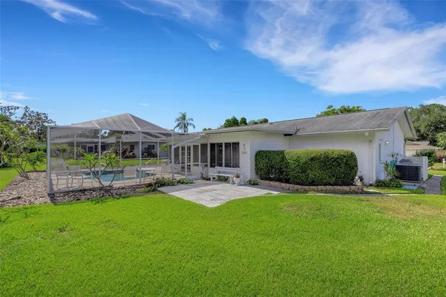 a view of a table and chairs in a backyard