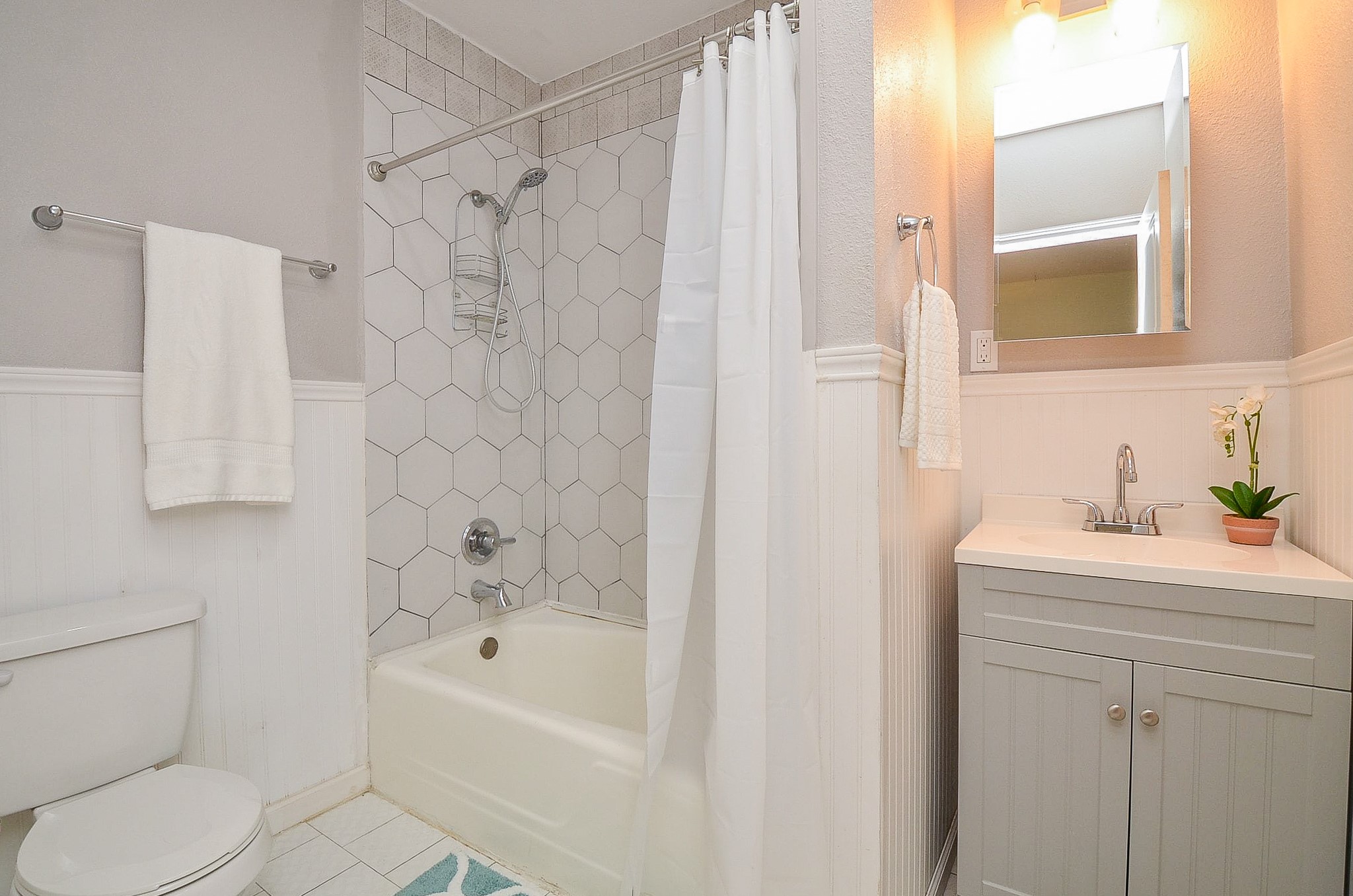 1615 Eagle Lake Road Sealy, TX 77474 - Photo 14 of 19 This secondary bathroom boasts a vanity with sink, storage and a medicine cabinet for additional items, plus a shower/tub combination with pretty tile surround!