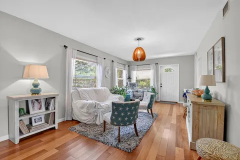 a living room with furniture and wooden floor