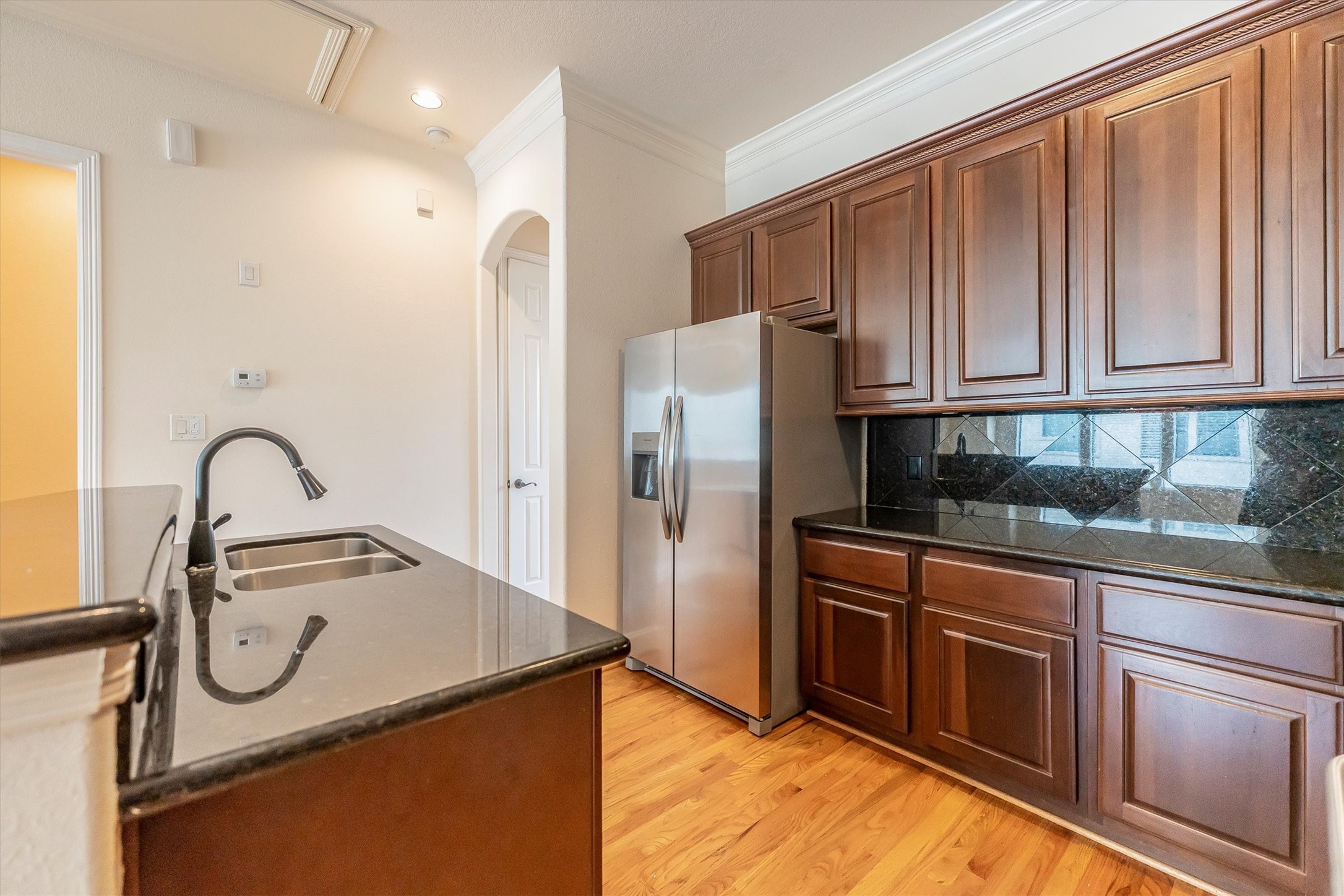 308 Grove Street Houston, TX 77020 - Photo 11 of 28 a kitchen with granite countertop a refrigerator and a stove top oven