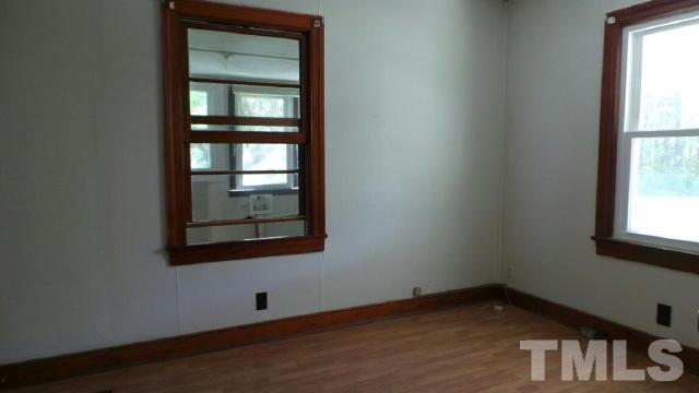 2841 Us 158 Roxboro, NC 27574 - Photo 3 of 6 a view of an empty room with wooden floor and a window