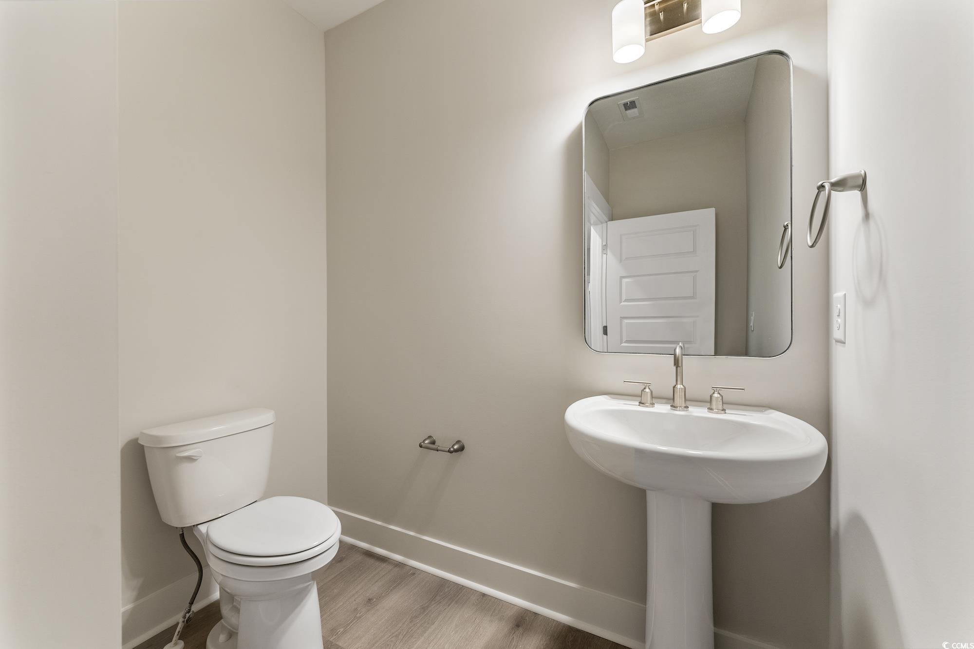 719 Daisy Bank Circle Georgetown, SC 29440 - Photo 17 of 33 Half bathroom featuring toilet and light wood-type flooring