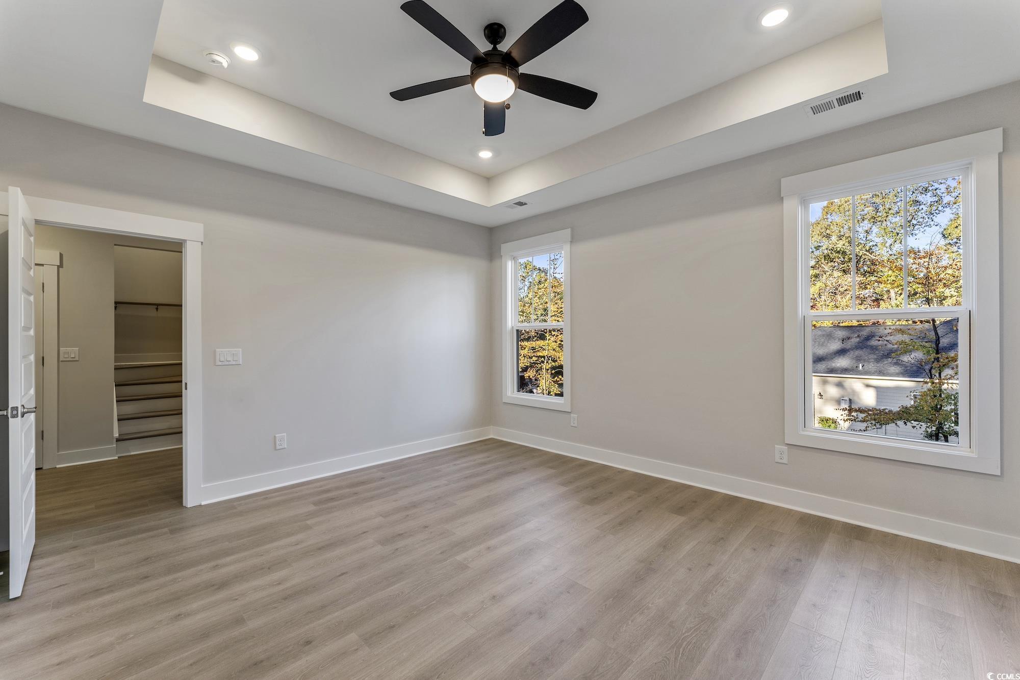 719 Daisy Bank Circle Georgetown, SC 29440 - Photo 20 of 33 Spare room with a raised ceiling, light wood finished floors, a ceiling fan, stairway, and recessed lighting
