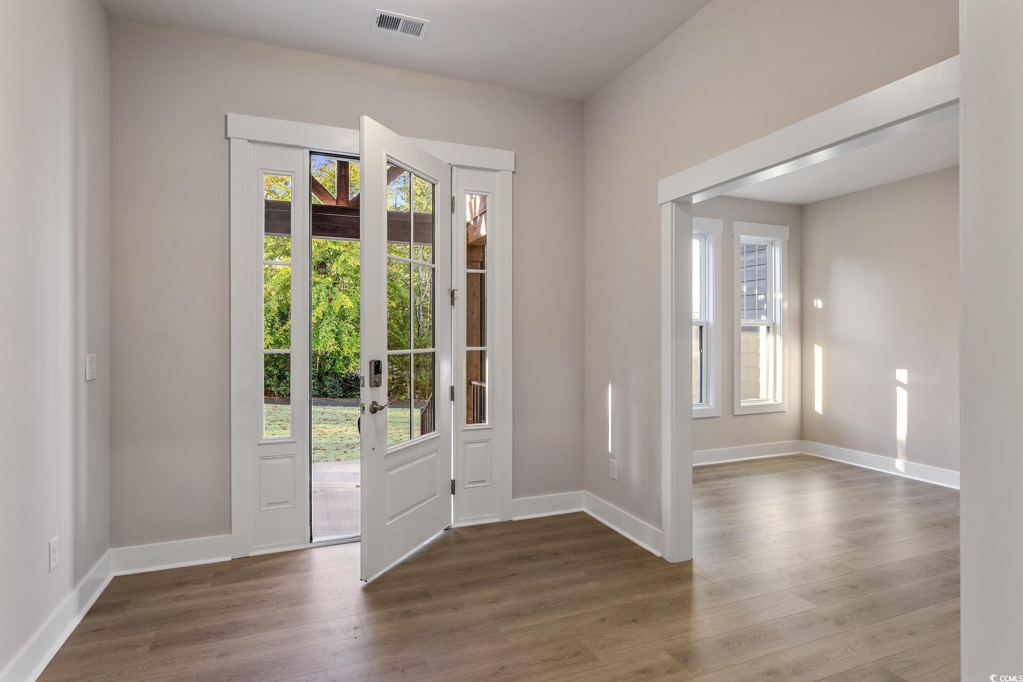 719 Daisy Bank Circle Georgetown, SC 29440 - Photo 2 of 33 Entrance foyer featuring healthy amount of natural light and wood finished floors