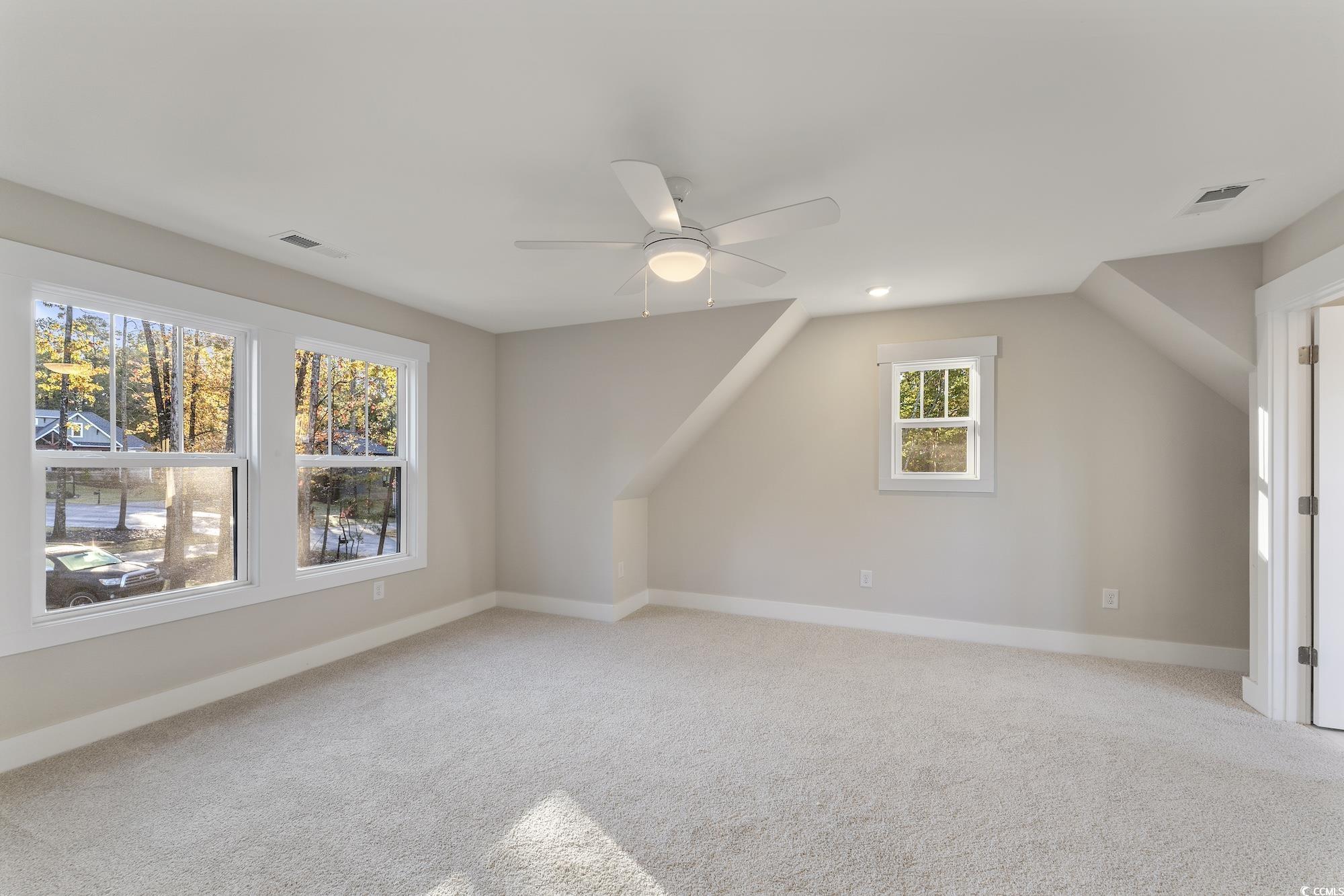 719 Daisy Bank Circle Georgetown, SC 29440 - Photo 26 of 33 Additional living space with light carpet, lofted ceiling, and a ceiling fan