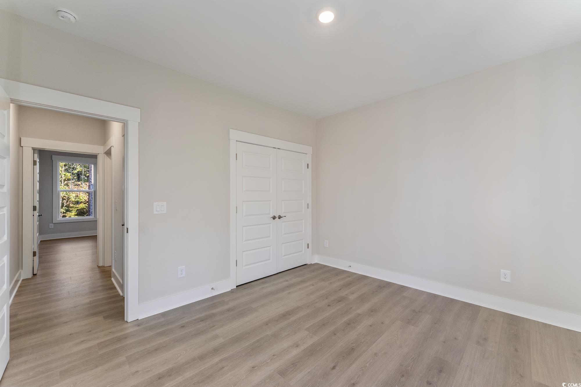 719 Daisy Bank Circle Georgetown, SC 29440 - Photo 30 of 33 Unfurnished bedroom featuring light wood-type flooring and a closet