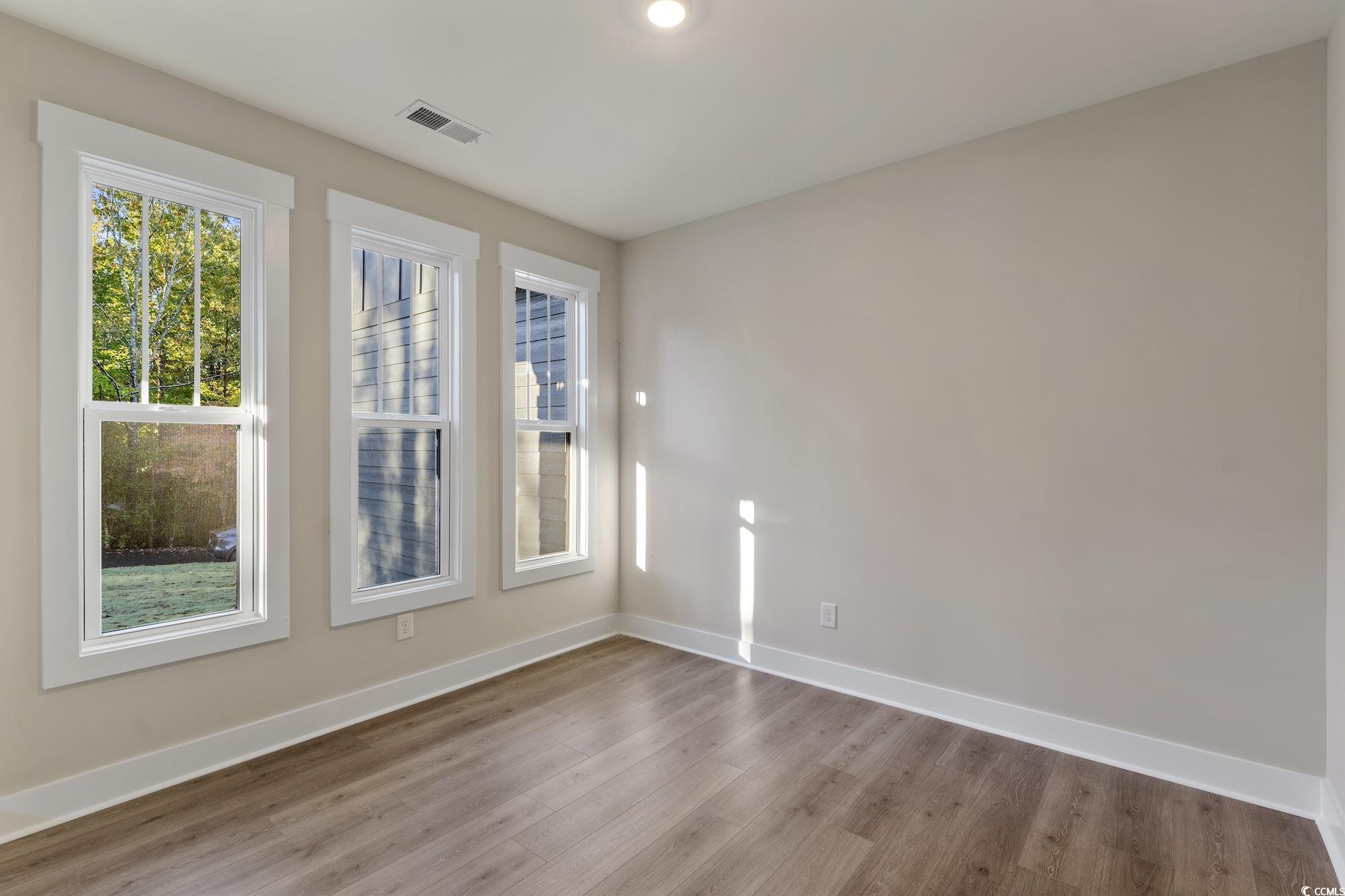 719 Daisy Bank Circle Georgetown, SC 29440 - Photo 3 of 33 Unfurnished room featuring plenty of natural light and wood finished floors
