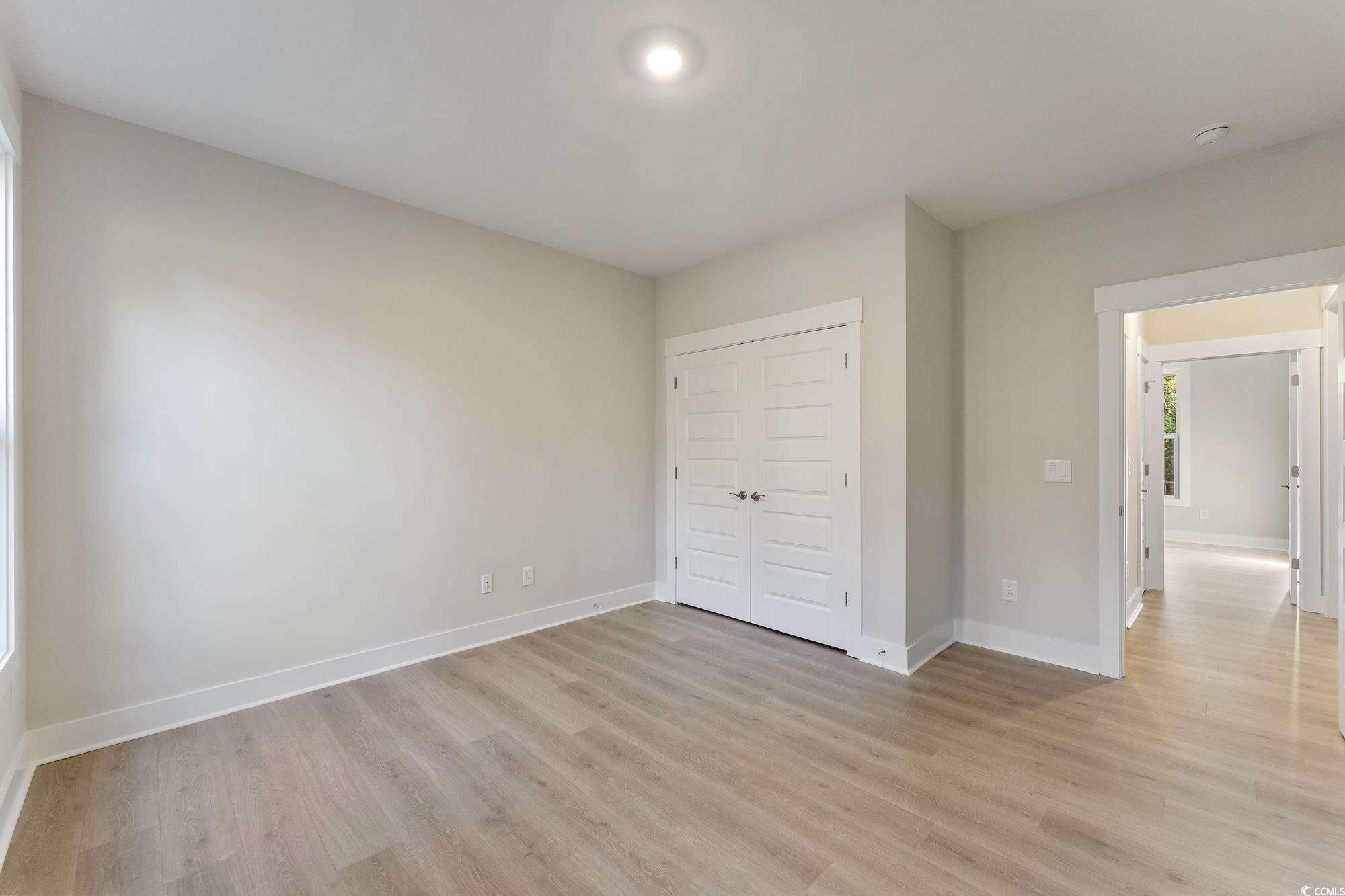 719 Daisy Bank Circle Georgetown, SC 29440 - Photo 33 of 33 Unfurnished bedroom with a closet and light wood-style floors