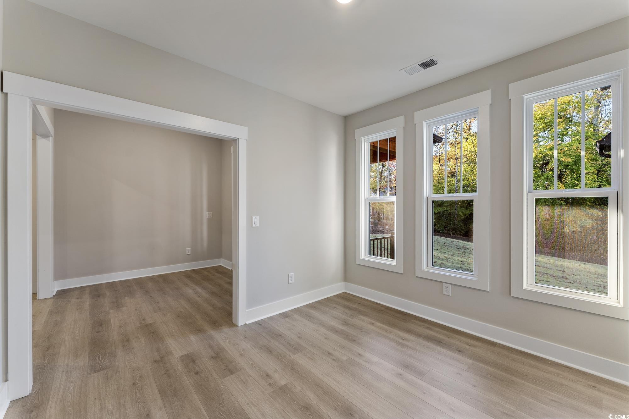 719 Daisy Bank Circle Georgetown, SC 29440 - Photo 4 of 33 Unfurnished room featuring baseboards and light wood-type flooring