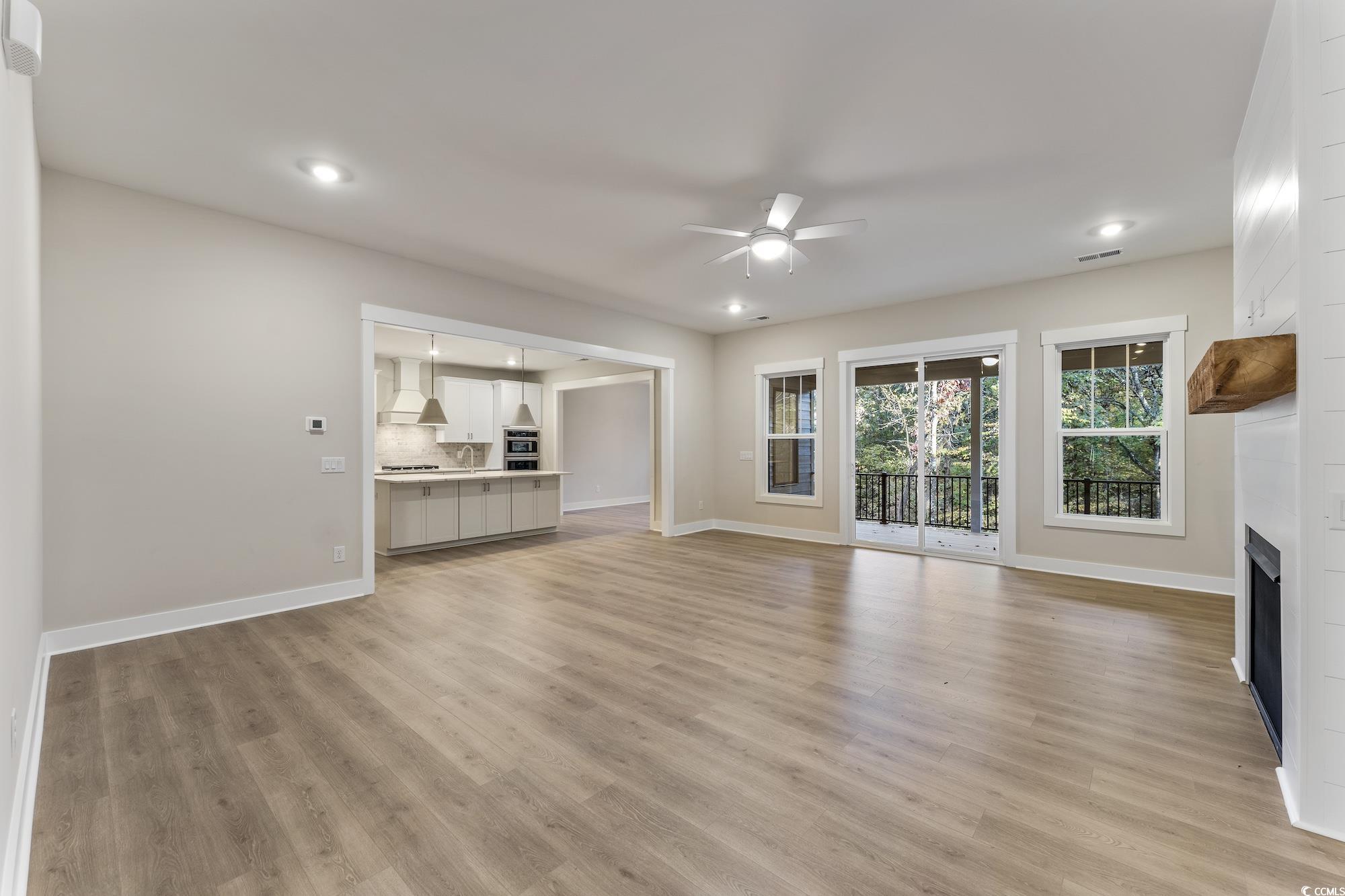 719 Daisy Bank Circle Georgetown, SC 29440 - Photo 5 of 33 Unfurnished living room with light wood-style floors, a fireplace, a ceiling fan, and recessed lighting