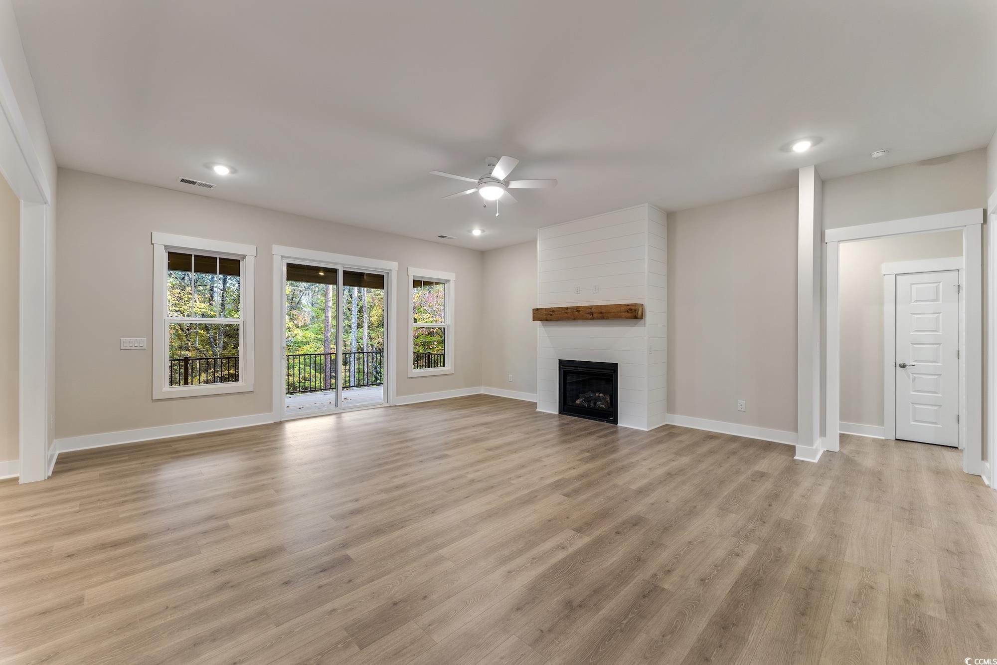719 Daisy Bank Circle Georgetown, SC 29440 - Photo 6 of 33 Unfurnished living room with a ceiling fan, a fireplace, light wood-style flooring, and recessed lighting