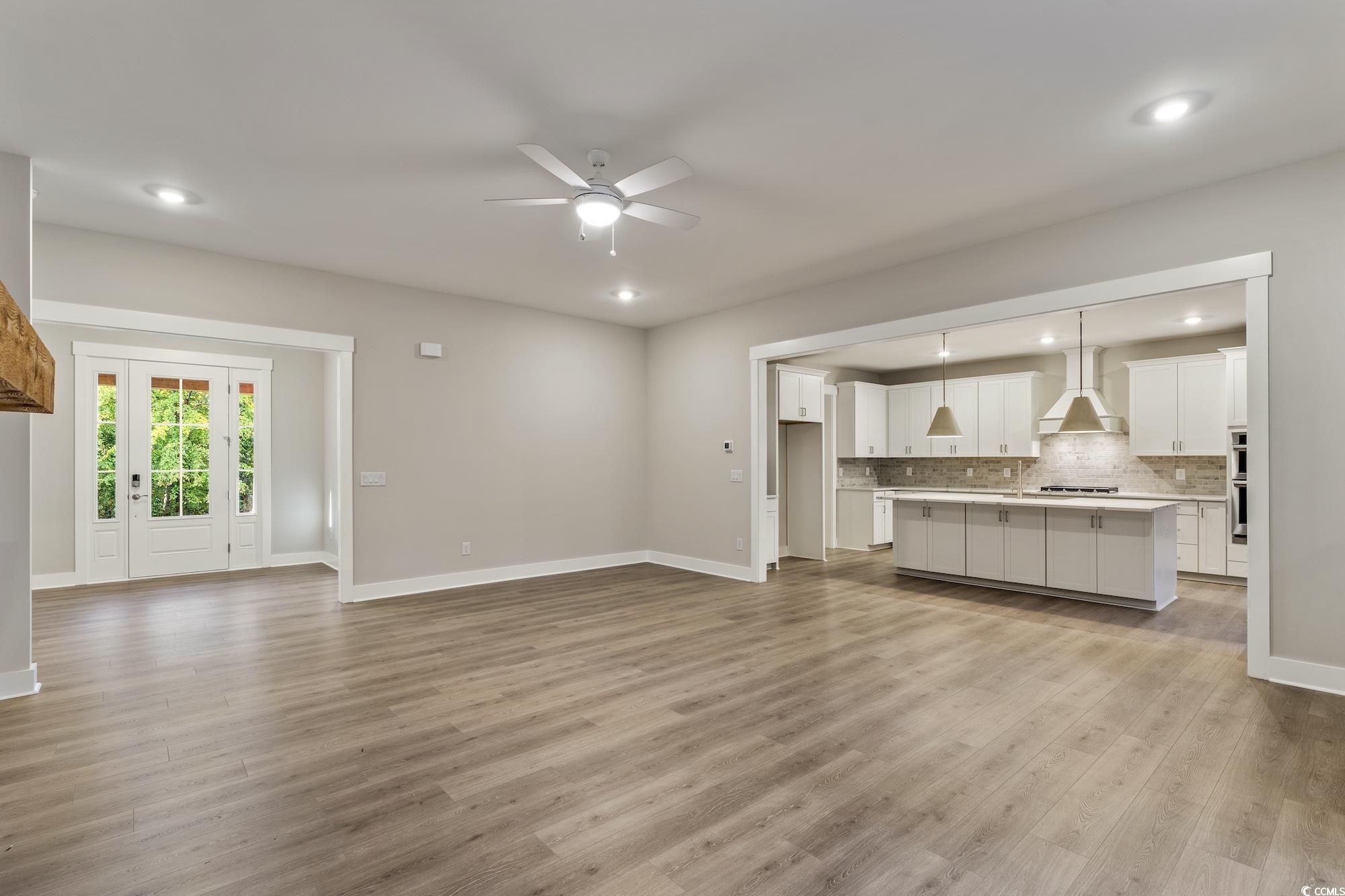 719 Daisy Bank Circle Georgetown, SC 29440 - Photo 9 of 33 Unfurnished living room with ceiling fan, light wood-style flooring, and recessed lighting
