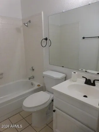 a bathroom with a shower a toilet and a sink