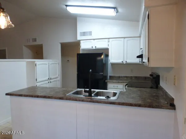 a kitchen with kitchen island sink refrigerator and microwave