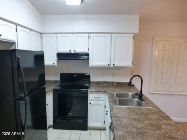 a kitchen with a sink and a refrigerator
