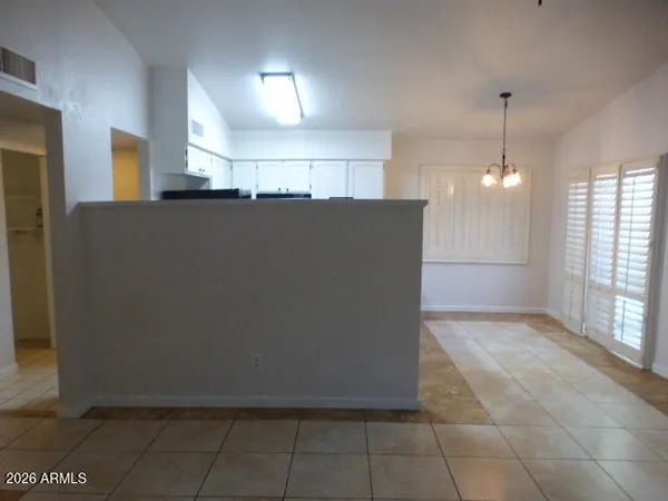 a kitchen with granite countertop a refrigerator sink and cabinets