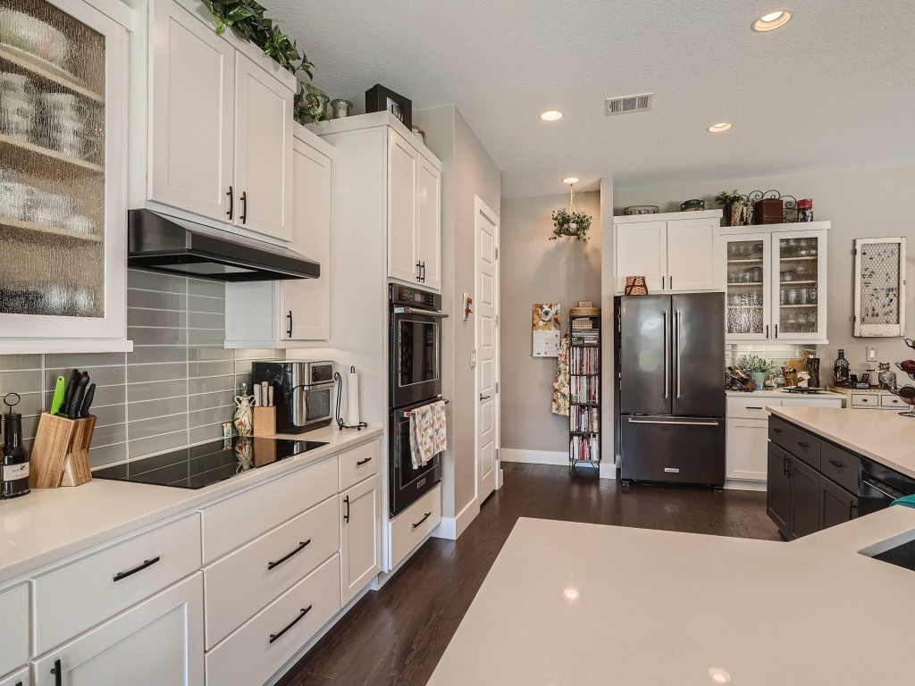 a kitchen with stainless steel appliances a refrigerator sink and stove