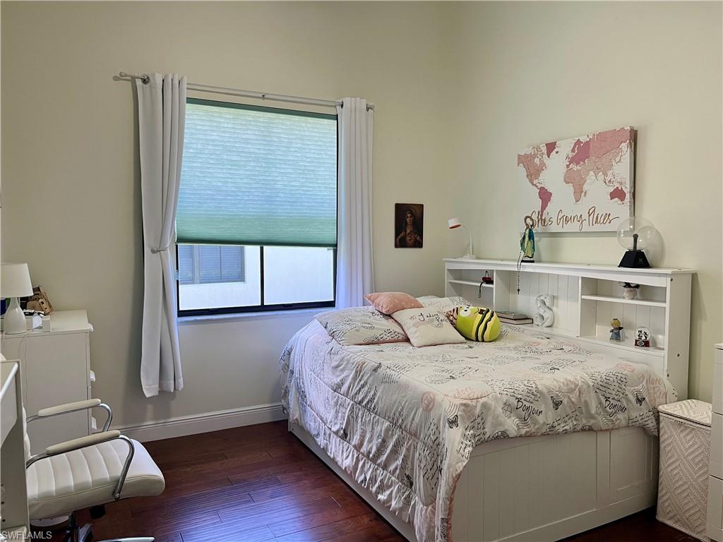 5351 Ferrari Avenue Ave Maria, FL 34142 - Photo 11 of 24 a bedroom with a bed and wooden floor