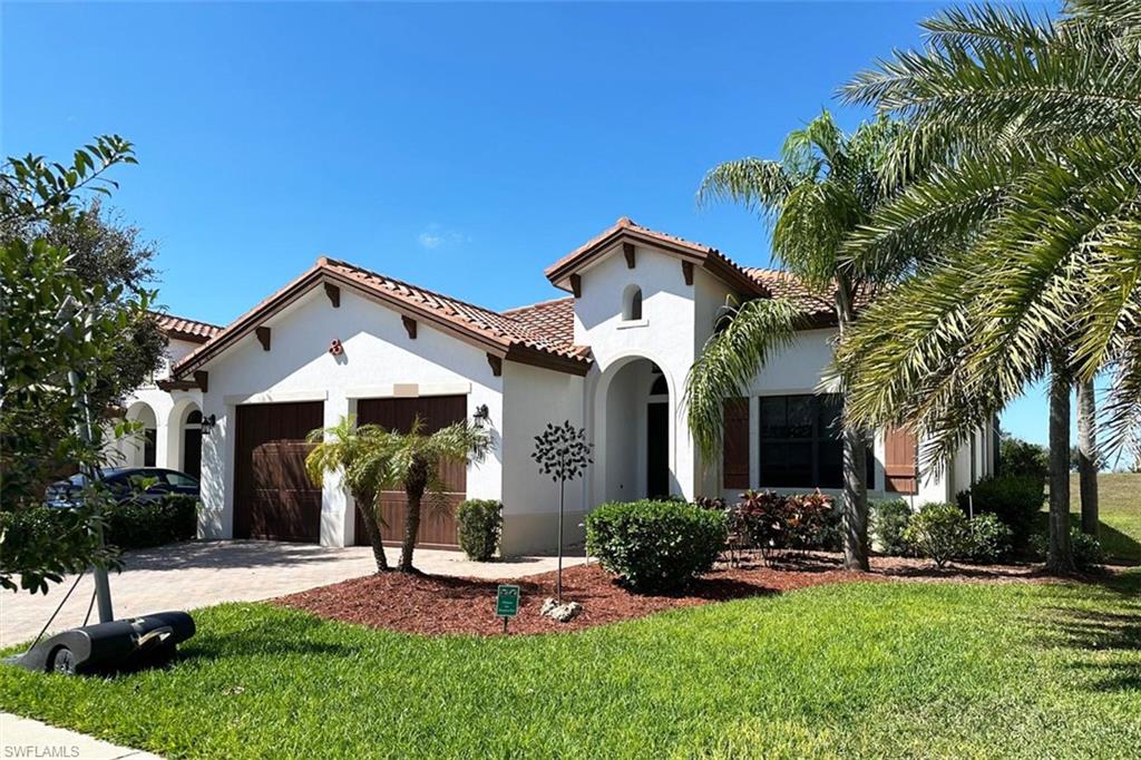 5351 Ferrari Avenue Ave Maria, FL 34142 - Photo 2 of 24 a front view of a house with a yard