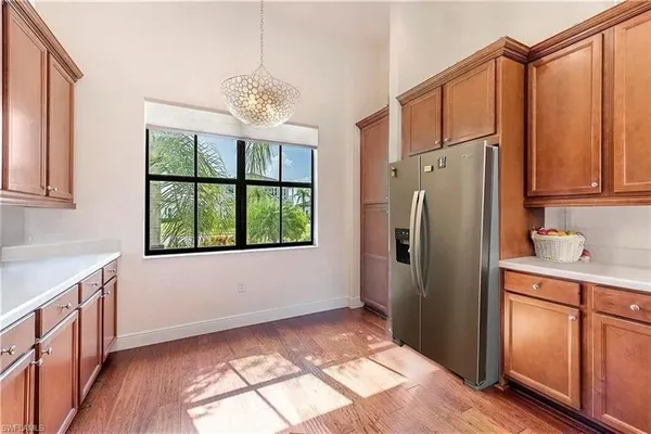 a kitchen with stainless steel appliances granite countertop a refrigerator and a sink