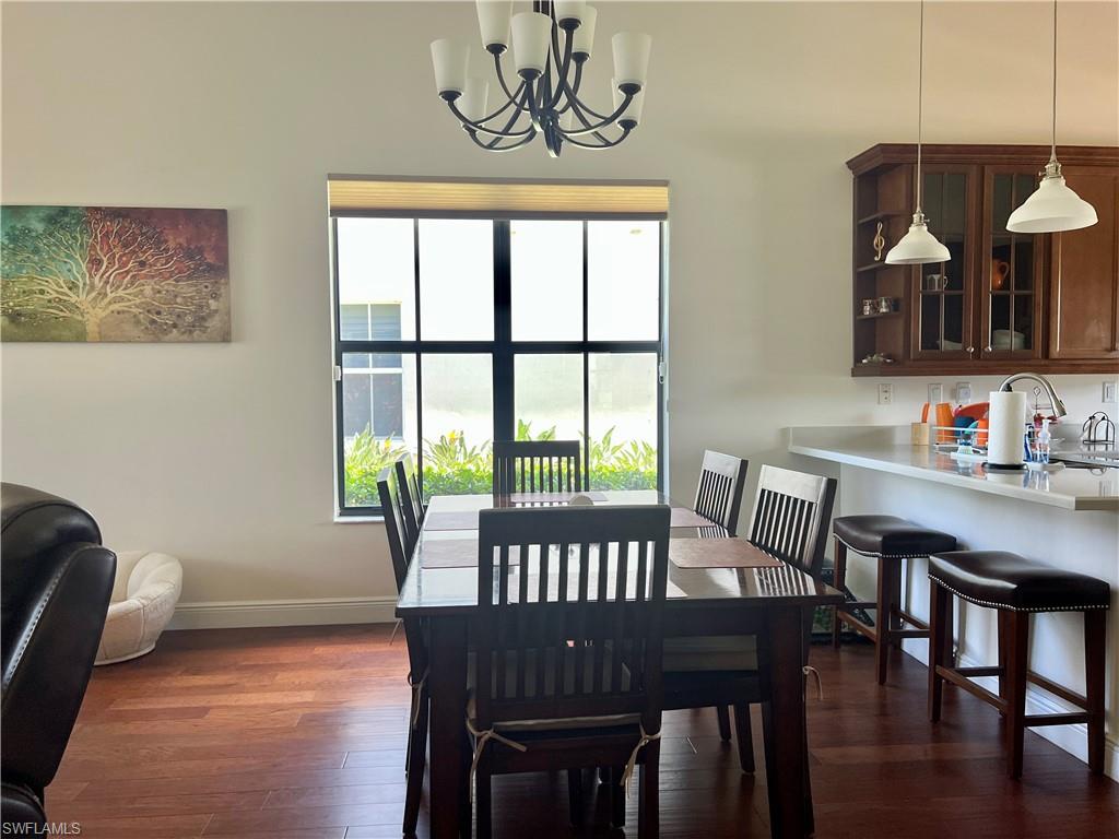 5351 Ferrari Avenue Ave Maria, FL 34142 - Photo 8 of 24 a view of a dining room with furniture window and wooden floor