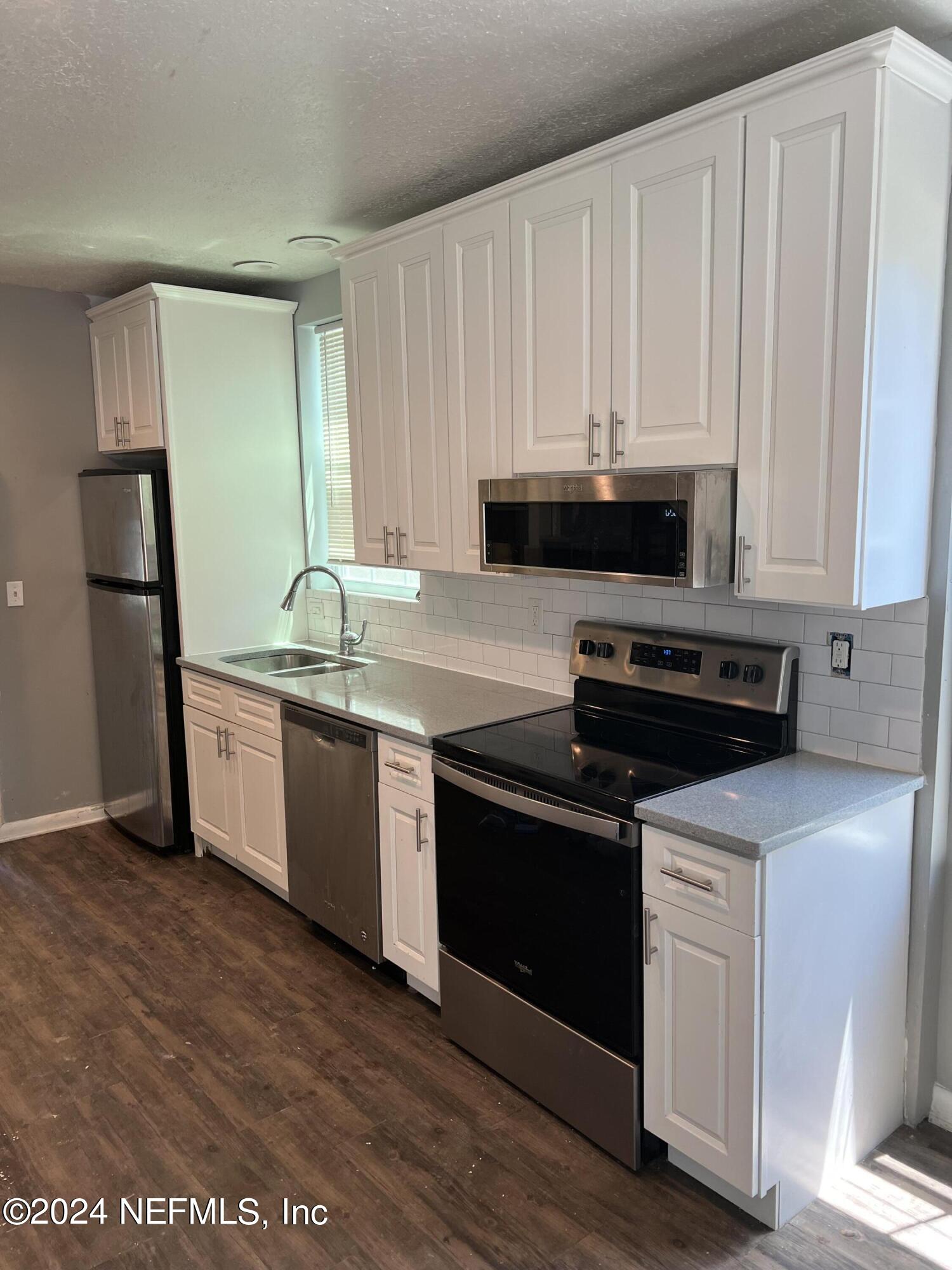 2829 Forbes Street Jacksonville, FL 32205 - Photo 4 of 5 a kitchen with a sink and a stove top oven