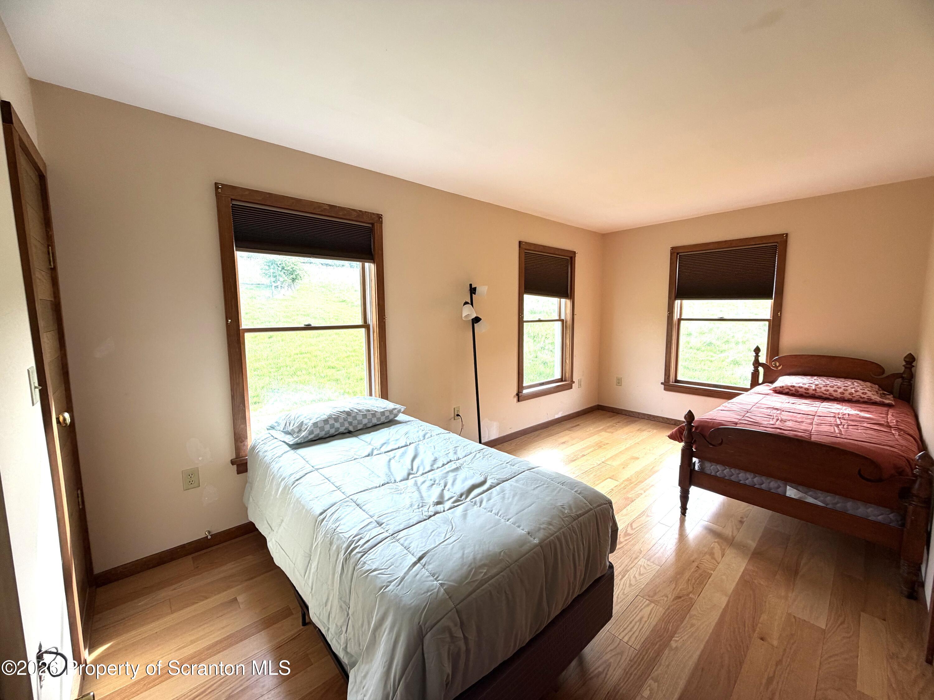 5290 Irish Hill Road Montrose, PA 18801 - Photo 37 of 67 a bedroom with a bed and a window