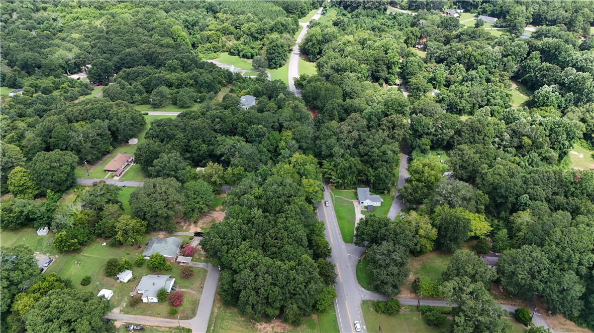 0 Keese Street Pendleton, SC 29670 - Photo 12 of 14 An aerial perspective reveals a tree-filled neighborhood with scattered homes and winding roads, offering a peaceful, natural setting.