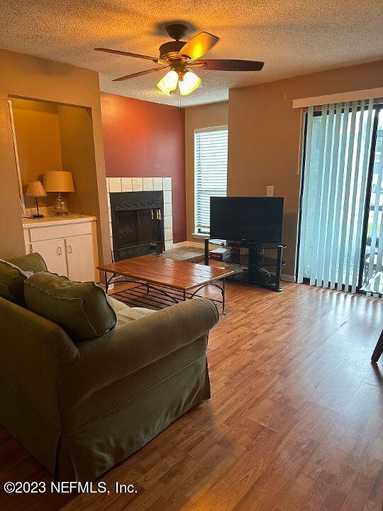 10200 Belle Rive Boulevard, Unit 239 Jacksonville, FL 32256 - Photo 15 of 27 a living room with furniture a fireplace and a flat screen tv