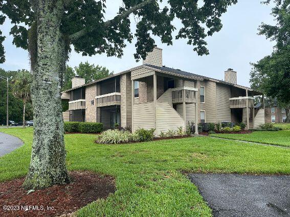 10200 Belle Rive Boulevard, Unit 239 Jacksonville, FL 32256 - Photo 2 of 27 a front view of a house with a yard