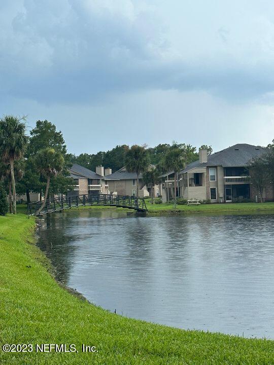 10200 Belle Rive Boulevard, Unit 239 Jacksonville, FL 32256 - Photo 21 of 27 a view of a lake with houses in the background