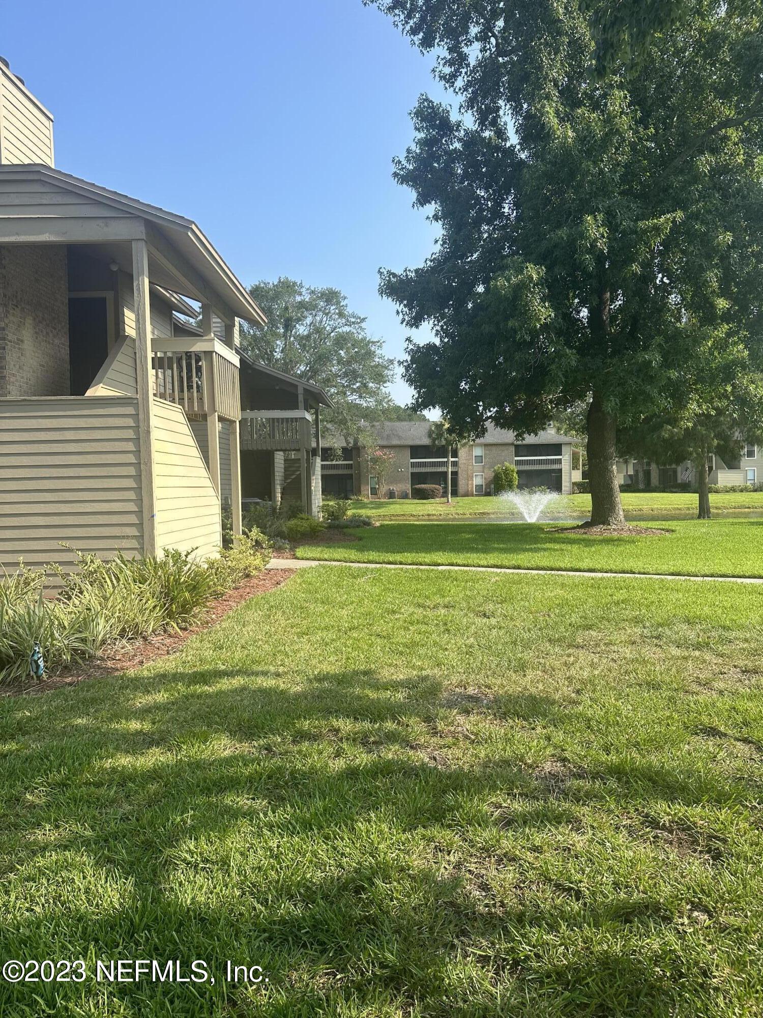 10200 Belle Rive Boulevard, Unit 239 Jacksonville, FL 32256 - Photo 3 of 27 a front view of a house with a yard