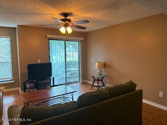 10200 Belle Rive Boulevard, Unit 239 Jacksonville, FL 32256 - Photo 9 of 27 a living room with furniture and a flat screen tv