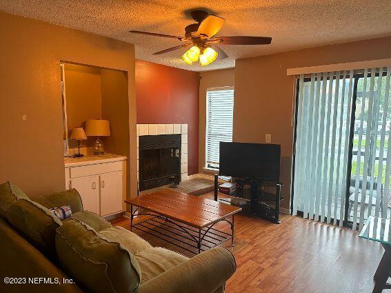10200 Belle Rive Boulevard, Unit 239 Jacksonville, FL 32256 - Photo 10 of 27 a living room with furniture a fireplace and a flat screen tv